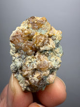 Load image into Gallery viewer, Hessonite Garnet Cluster on Matrix – Natural Collector Specimen from Pakistan | High-Grade Orange-Red Garnet Crystals
