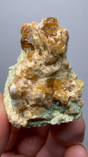Load and play video in Gallery viewer, Hessonite Garnet Cluster on Matrix – Natural Collector Specimen from Pakistan | High-Grade Orange-Red Garnet Crystals
